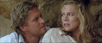 Movie still from “The Jewel of the Nile” (1985), directed by Lewis Teague – A man and a woman looking at one another; Close Up shot, Low angle