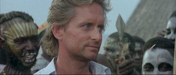 Movie still from “The Jewel of the Nile” (1985), directed by Lewis Teague – A person wearing a white shirt; Close Up shot, Over the shoulder angle