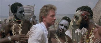 Movie still from “The Jewel of the Nile” (1985), directed by Lewis Teague – A man and a woman with face paint on; Close Up shot, Over the shoulder angle