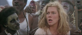 Movie still from “The Jewel of the Nile” (1985), directed by Lewis Teague – A person with a crowd of people; Close Up shot, Low angle
