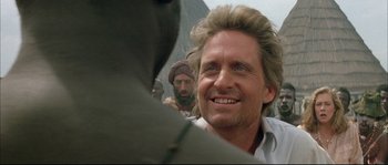 Movie still from “The Jewel of the Nile” (1985), directed by Lewis Teague – A person with long hair and a beard; Close Up shot, Over the shoulder angle