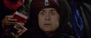 Movie still from “The Jewel of the Nile” (1985), directed by Lewis Teague – A person wearing a hat; Close Up shot, Low angle