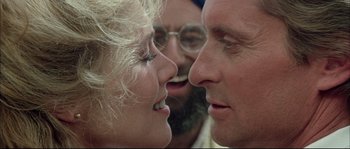 Movie still from “The Jewel of the Nile” (1985), directed by Lewis Teague – A man and a woman face to face with one another; Close Up shot, Over the shoulder angle
