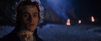 Movie still from “Queen of the Damned” (2002), directed by Michael Rymer – A person wearing a hat; Close Up shot, Over the shoulder angle