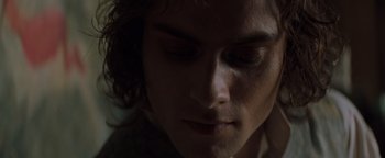 Movie still from “Queen of the Damned” (2002), directed by Michael Rymer – A person's face with a dark background; Close Up shot, Over the shoulder angle