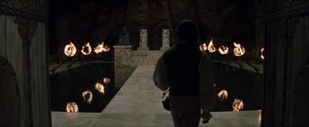 Movie still from “Queen of the Damned” (2002), directed by Michael Rymer – A person walking in front of a body of water; Wide shot, High angle