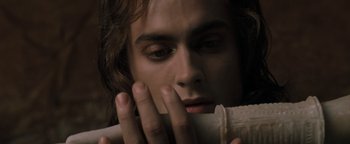 Movie still from “Queen of the Damned” (2002), directed by Michael Rymer – A man holding a piece of paper in his hands; Close Up shot, Overhead angle