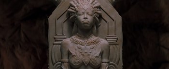 Movie still from “Queen of the Damned” (2002), directed by Michael Rymer – A statue of a woman with a crown on her head; Close Up shot, High angle