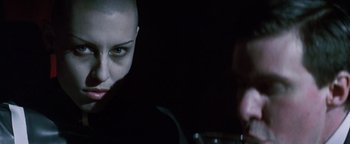 Movie still from “Queen of the Damned” (2002), directed by Michael Rymer – A woman with a bald head is looking into the camera; Close Up shot, Over the shoulder angle