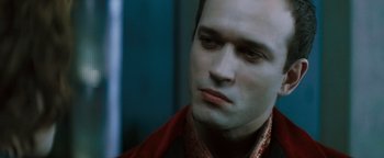 Movie still from “Queen of the Damned” (2002), directed by Michael Rymer – A person wearing a suit and tie; Close Up shot, Over the shoulder angle