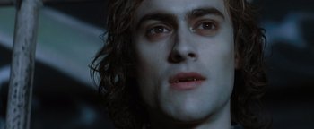 Movie still from “Queen of the Damned” (2002), directed by Michael Rymer – A man's face with long dark hair; Close Up shot, Overhead angle