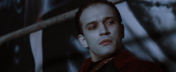 Movie still from “Queen of the Damned” (2002), directed by Michael Rymer – A person wearing a red jacket; Close Up shot, High angle