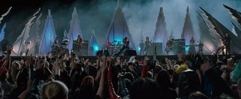 Movie still from “Queen of the Damned” (2002), directed by Michael Rymer – A crowd of people standing around a stage; Extreme Wide shot, High angle