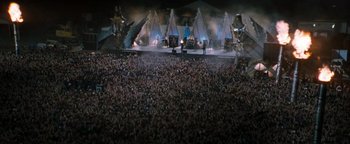 Movie still from “Queen of the Damned” (2002), directed by Michael Rymer – A large crowd of people at an outdoor concert; Extreme Wide shot, High angle