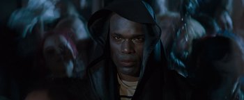 Movie still from “Queen of the Damned” (2002), directed by Michael Rymer – A man in a hooded jacket stares into the camera; Close Up shot, Low angle