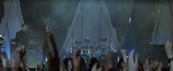 Movie still from “Queen of the Damned” (2002), directed by Michael Rymer – A group of people standing in front of a drum set; Extreme Wide shot, High angle