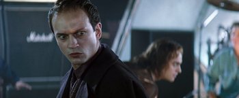 Movie still from “Queen of the Damned” (2002), directed by Michael Rymer – A person wearing a suit and tie; Close Up shot, Low angle