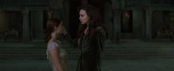 Movie still from “Queen of the Damned” (2002), directed by Michael Rymer – A woman touching the forehead of another woman; Medium shot, Over the shoulder angle