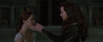 Movie still from “Queen of the Damned” (2002), directed by Michael Rymer – A woman holding her hand out to another woman; Close Up shot, Over the shoulder angle