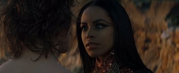 Movie still from “Queen of the Damned” (2002), directed by Michael Rymer – A woman with long black hair wearing a red dress; Close Up shot, Over the shoulder angle