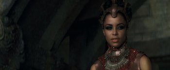 Movie still from “Queen of the Damned” (2002), directed by Michael Rymer – A woman in a red and black outfit with a necklace; Close Up shot, Over the shoulder angle