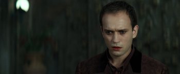 Movie still from “Queen of the Damned” (2002), directed by Michael Rymer – A person wearing a suit and tie; Close Up shot, High angle