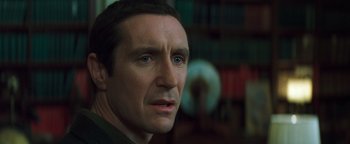 Movie still from “Queen of the Damned” (2002), directed by Michael Rymer – A man's face in front of a bookshelf; Close Up shot, Over the shoulder angle