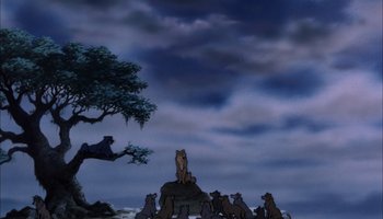 Movie still from “The Jungle Book” (1967), directed by Wolfgang Reitherman – A group of animals sitting on top of a rock under a cloudy sky; Wide shot, Low angle