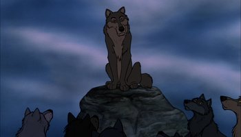 Movie still from “The Jungle Book” (1967), directed by Wolfgang Reitherman – A wolf sitting on top of a rock in the middle of the night; Wide shot, Low angle