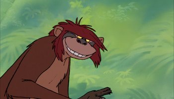 Movie still from “The Jungle Book” (1967), directed by Wolfgang Reitherman – A cartoon of a monkey with red hair and an evil grin; Close Up shot, Low angle