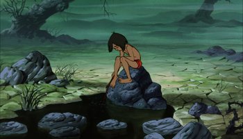 Movie still from “The Jungle Book” (1967), directed by Wolfgang Reitherman – An animated scene of a person sitting on a rock; Wide shot, High angle