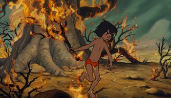 Movie still from “The Jungle Book” (1967), directed by Wolfgang Reitherman – A young boy is running through the flames of a fire; Wide shot, High angle