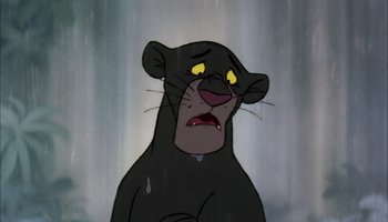 Movie still from “The Jungle Book” (1967), directed by Wolfgang Reitherman – A black cat with yellow eyes is looking sad; Close Up shot, Low angle