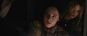 Movie still from “The Kid” (2019), directed by Vincent D'Onofrio – A young girl is looking into the camera; Close Up shot, Low angle