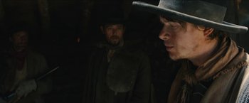 Movie still from “The Kid” (2019), directed by Vincent D'Onofrio – A man in a black hat and a man in a black jacket; Close Up shot, Over the shoulder angle