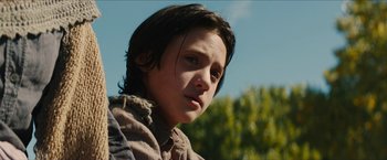 Movie still from “The Kid” (2019), directed by Vincent D'Onofrio – A person with long black hair; Close Up shot, Low angle