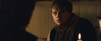 Movie still from “The Kid” (2019), directed by Vincent D'Onofrio – A young man looking into a mirror while wearing a scarf; Close Up shot, Over the shoulder angle