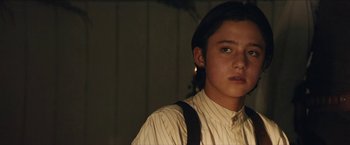 Movie still from “The Kid” (2019), directed by Vincent D'Onofrio – A young man wearing a white shirt and suspenders; Close Up shot, Low angle