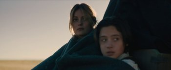 Movie still from “The Kid” (2019), directed by Vincent D'Onofrio – Two women wrapped in a blanket looking at the camera; Close Up shot, Low angle