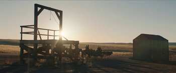 Movie still from “The Kid” (2019), directed by Vincent D'Onofrio – A group of people riding on the back of a horse drawn carriage; Extreme Wide shot, Low angle