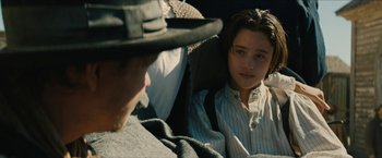 Movie still from “The Kid” (2019), directed by Vincent D'Onofrio – A young boy sitting next to a man in a car seat; Close Up shot, Over the shoulder angle