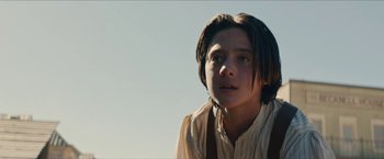 Movie still from “The Kid” (2019), directed by Vincent D'Onofrio – A young man with long brown hair looking at the camera; Close Up shot, Low angle