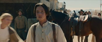 Movie still from “The Kid” (2019), directed by Vincent D'Onofrio – A young man standing in front of a horse; Close Up shot, Over the shoulder angle