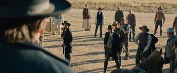 Movie still from “The Kid” (2019), directed by Vincent D'Onofrio – A group of men in suits and hats standing in the dirt; Wide shot, Over the shoulder angle