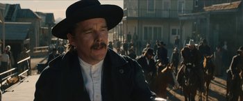 Movie still from “The Kid” (2019), directed by Vincent D'Onofrio – A man in a black hat and a white shirt; Close Up shot, Over the shoulder angle