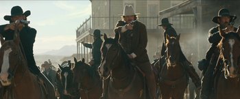 Movie still from “The Kid” (2019), directed by Vincent D'Onofrio – A group of men riding on the backs of horses; Medium shot, Low angle