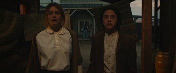 Movie still from “The Kid” (2019), directed by Vincent D'Onofrio – Two people standing next to each other on a street; Medium shot, Low angle