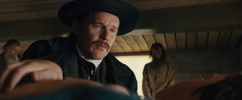 Movie still from “The Kid” (2019), directed by Vincent D'Onofrio – A person wearing a hat; Close Up shot, Over the shoulder angle