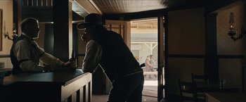 Movie still from “The Kid” (2019), directed by Vincent D'Onofrio – A man leaning on a counter in a bar; Medium shot, Over the shoulder angle