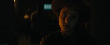 Movie still from “The Kid” (2019), directed by Vincent D'Onofrio – A young boy wearing a hat in the dark; Close Up shot, Over the shoulder angle
